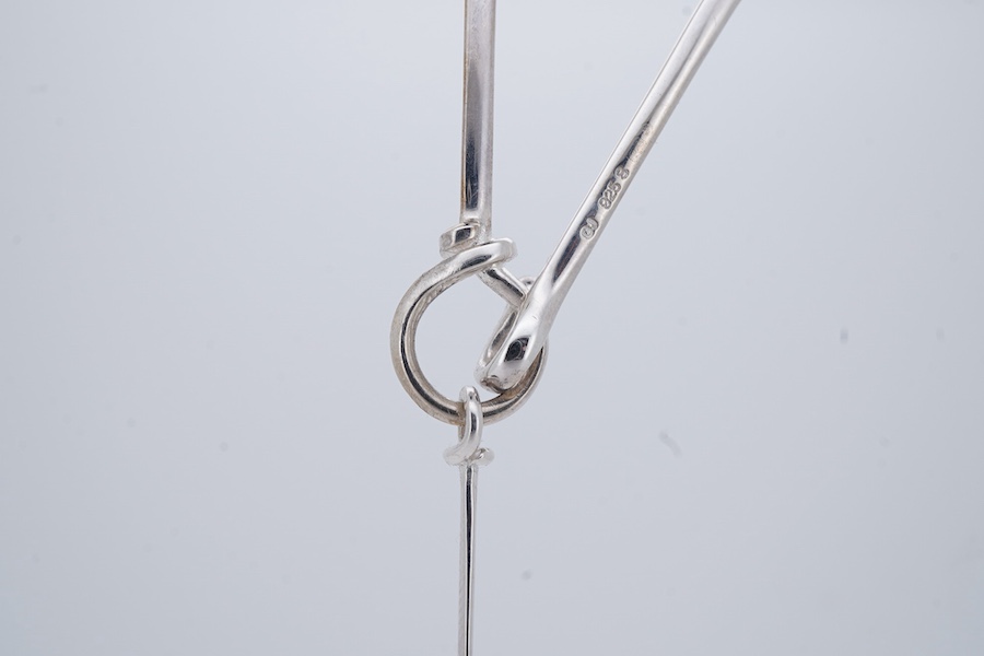 Georg Jensen, a blue topaz necklace, centring on a hook clasp suspending an oval blue topaz pendant, pendant length 5.5cm, necklace length 43cm, stamped GJ for Georg Jensen, 925S and European convention assay marks for s